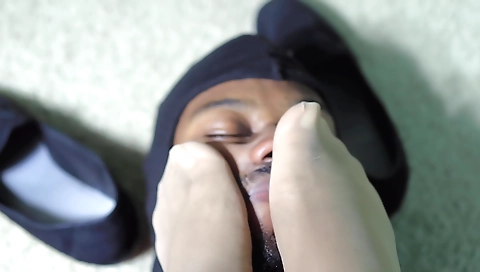 Curvaceous goddess works and ignores human foot stool